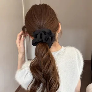 Black satin hair scrunchie ponytail holder, elegant elastic hair tie for women daily styling.