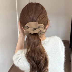 Satin hair scrunchie detail view, soft fabric ponytail holder for daily elegant styling.