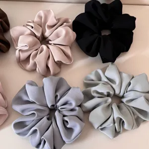 Detail shot of colorful fabric hair scrunchies showcasing soft texture and multiple color options.