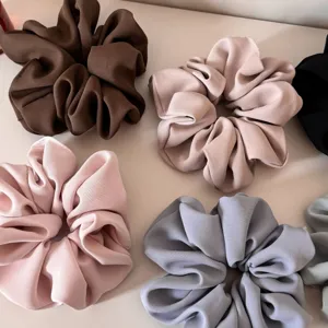 Details of chic satin hair scrunchies showcasing soft fabric texture and elegant color options.