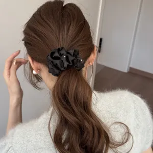 Elegant black satin hair scrunchie with delicate rhinestones for women ponytail styling.