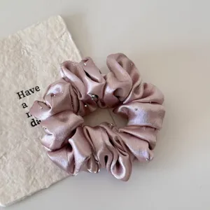 Pink satin hair scrunchie with rhinestone sparkle, elegant elastic ponytail holder.