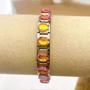 Stainless steel modular bracelet detail showcasing colorful crystal skull charm links for DIY jewelry.