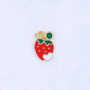 Close-up detail of the sweet strawberry fruit pendant charm with gold edge and enamel finish.