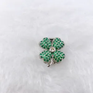 Detailed view of a green rhinestone four-leaf clover pendant accessory for DIY jewelry.