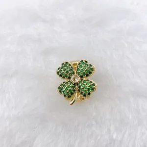 Detail view of gold plated four leaf clover DIY jewelry accessory with green zircon stones.