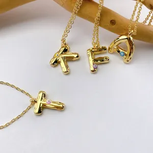 Gold plated alphabet letter pendant necklace with evil eye design, chic fashion jewelry accessory.