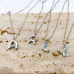 Silver letter pendant necklaces featuring evil eye details, gorgeous close-up view.