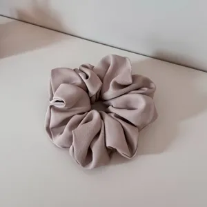 Elegant fabric hair scrunchie for women, soft satin ponytail holder daily hair accessory.