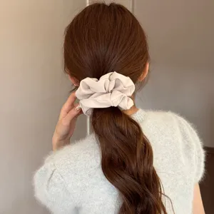 French satin hair scrunchie for women, elegant beige ponytail holder, stylish hair accessory.