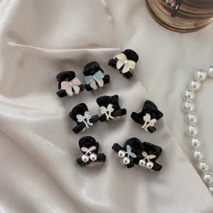 Close-up details of sweet black alloy mini hair claw clips featuring cute bows and pearls.