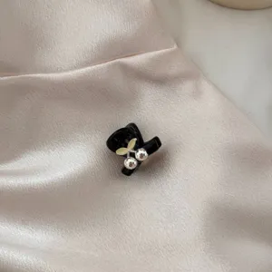 Mini black hair claw clip with cute cherry design, perfect for styling bangs and daily wear.