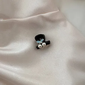 Chic black mini hair claw clip featuring elegant blue leaf and silver ball accents for daily styling.