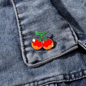 Enamel cherry brooch pin cute fruit alloy badge detail for clothes and bag decoration.