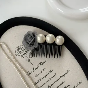 Detail view of vintage grey rose fabric hair comb with elegant white pearls for styling.