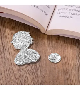 Detailed view of the cute cartoon metal brooch, perfect for student backpacks and stylish apparel.