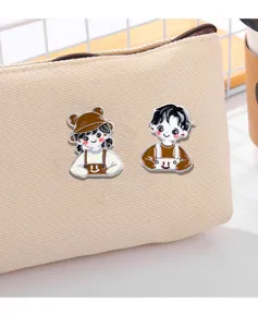 Cute cartoon couple metal enamel brooch detail shot, perfect for bags and jacket decoration.