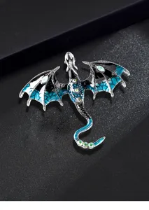 Detailed close-up of the gothic dragon brooch with blue enamel wings and shining crystals.