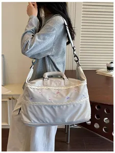 Large capacity travel duffel bag with lace trim, perfect for weekend trips and gym use.