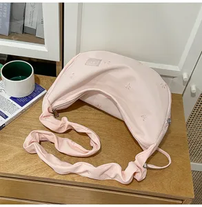 Pink pleated shoulder cloud bag with sweet bow embroidery for daily casual use.