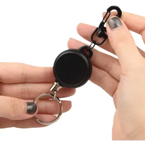 Detailed close-up of a black retractable key holder with a sturdy metal carabiner and ring.