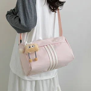 Casual large capacity pink cylindrical shoulder bag with three stripes and cute plush pendant.