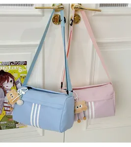Casual canvas cylinder crossbody bag for women, cute shoulder bag with bear pendant.