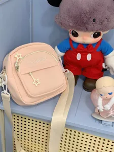 Pink canvas crossbody bag for women, cute multi-pocket casual shoulder bag with star charm and strap.