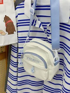 Casual canvas crossbody bag for women featuring blue strap and cute star charms.