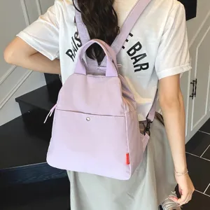 Casual purple canvas backpack for women, stylish minimalist daily travel school daypack.