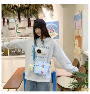Cute canvas crossbody bag for women, casual student shoulder bucket bag with lovely heart print.