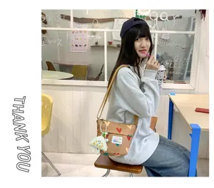 Cute canvas crossbody bag for women, casual shoulder bag with heart pattern for daily use.