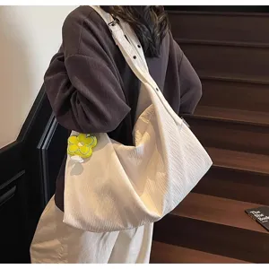 Vue détaillée du sac bandoulière en toile style décontracté, grande capacité et très pratique.