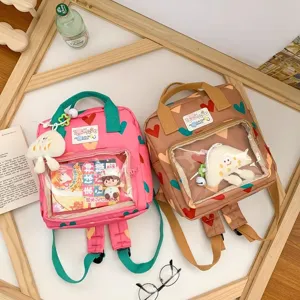 Cute sweet style mini backpack for girls with clear front pocket, heart pattern and plush doll.