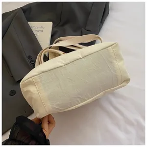 Detailed view of the casual beige canvas tote bag, featuring durable fabric and sturdy straps.