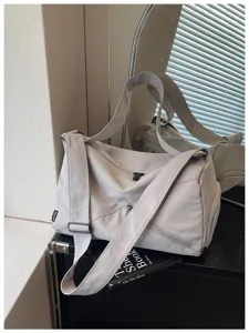 Sac de voyage gris avec bandoulière, grand sac de sport et d'entraînement pour femmes.