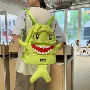Detail view of the cute green shark backpack with 3D fins, perfect for students and outdoor trips.