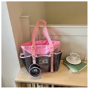 Close-up detail of the pink and black mesh tote swim bag featuring a handy attached small pouch.