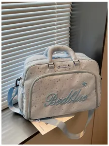 Detailed view of the light blue travel duffel bag with star pattern, casual and portable.