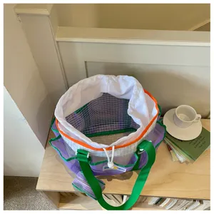 Waterproof mesh beach tote bag with drawstring inner lining and large capacity for travel.