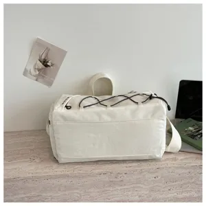 White canvas travel duffel bag with elastic cord for gym sports yoga and short trips.