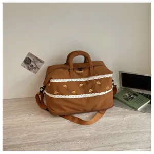 Large capacity travel duffle bag with lace embroidery and handles for short trips and gym use.