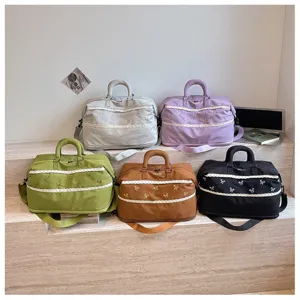 Detail view of multi-color travel duffel bags featuring cute lace trim and bows for storage.