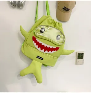 Cartoon shark backpack detail showing unique fish tail design, transparent eye cover and cute shark teeth.