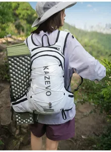 Detail shot of lightweight waterproof hiking backpack featuring vest design and side sleeping mat.