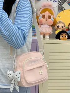 Casual Japanese style pink canvas crossbody bag for women, lightweight daily shoulder bag with cute bow.