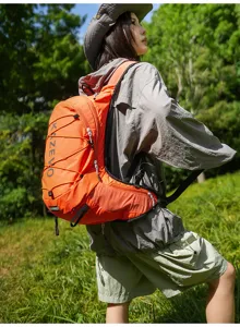 Detail view of the outdoor hiking backpack in bright orange, lightweight and waterproof.