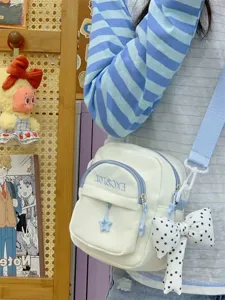 Close-up detail of Japanese canvas crossbody bag with front pocket and cute star pendant.