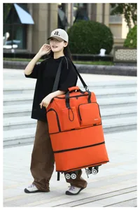 Gran bolsa de viaje plegable con ruedas universales, bolsa de lona rodante naranja.