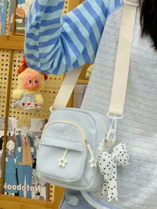 Summer Japanese multi-pocket casual canvas crossbody shoulder bag for women daily use.